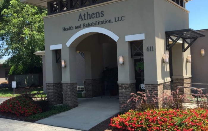 Entrance to Athens Health and Rehabilitation, LLC, with landscaped plants in front.