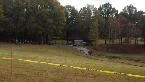 A view of a crime scene cordoned off with police tape, indicating an ongoing investigation.