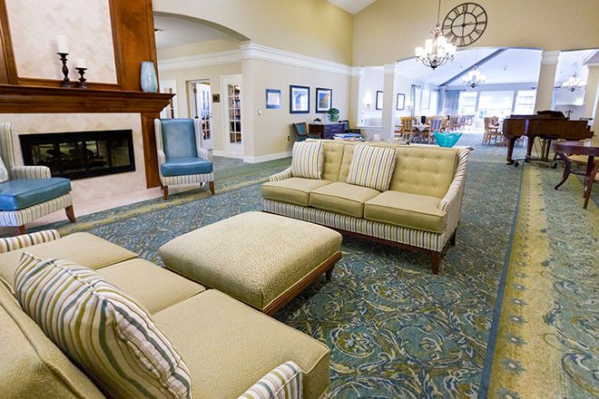A spacious and modern living room with comfortable seating and a fireplace.