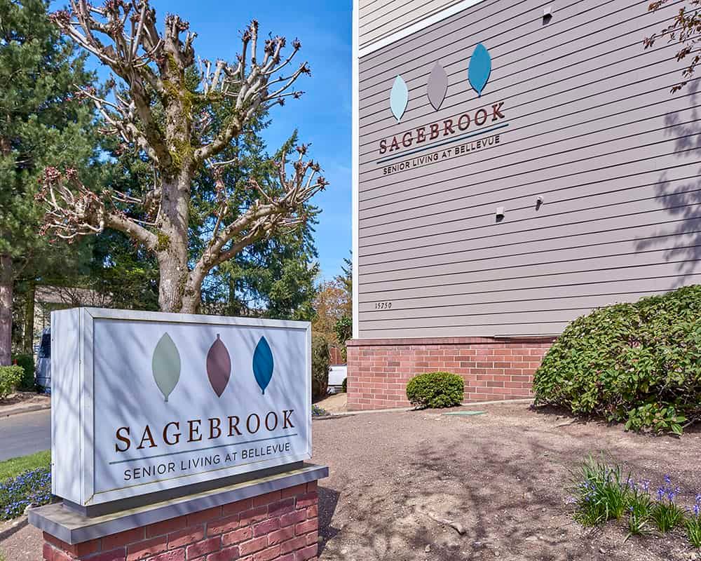 Signage outside Sagebrook Apartment Homes on a sunny day.