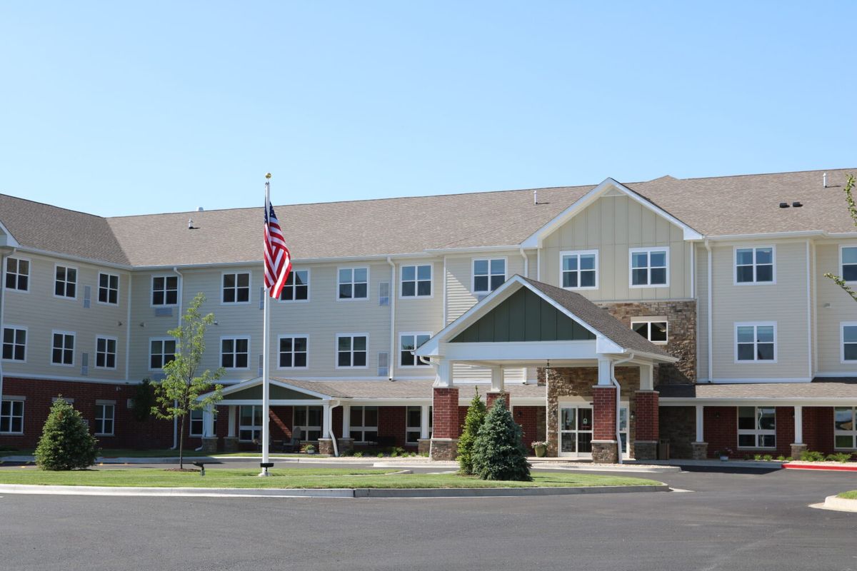 A residential building with an American flag displayed outside.