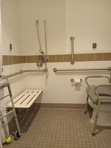 An accessible bathroom equipped with safety features for individuals with disabilities.