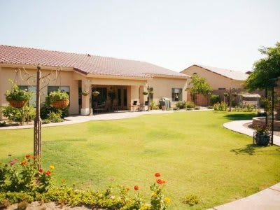 A spacious backyard with a well-maintained lawn and garden area.