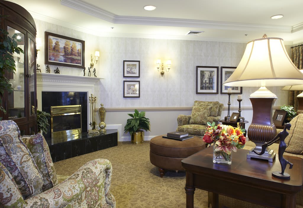 A cozy living room with elegant furniture, featuring a fireplace and soft lighting.