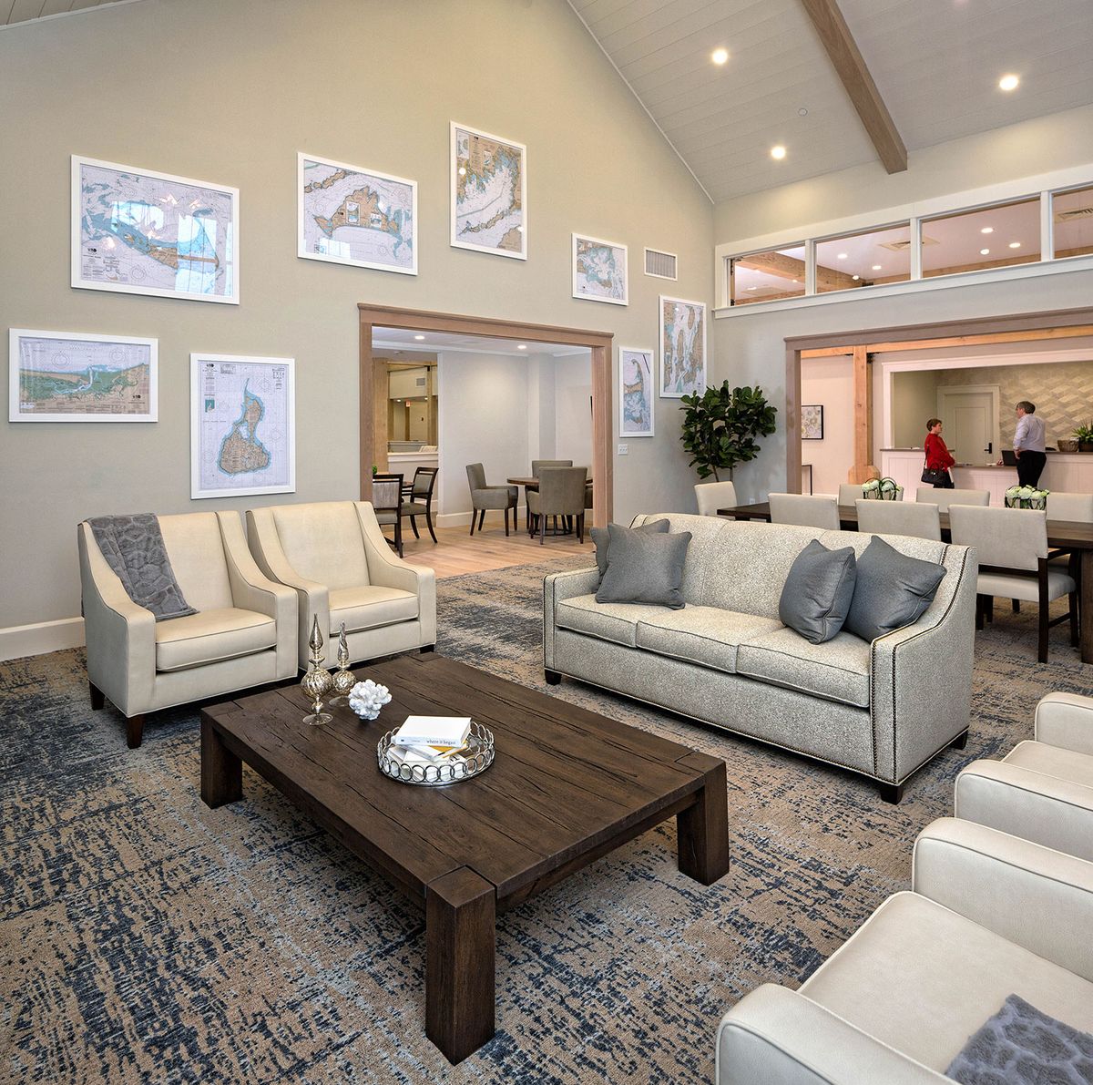 A modern living room with stylish sofas, a wooden coffee table, and framed artwork on the walls.