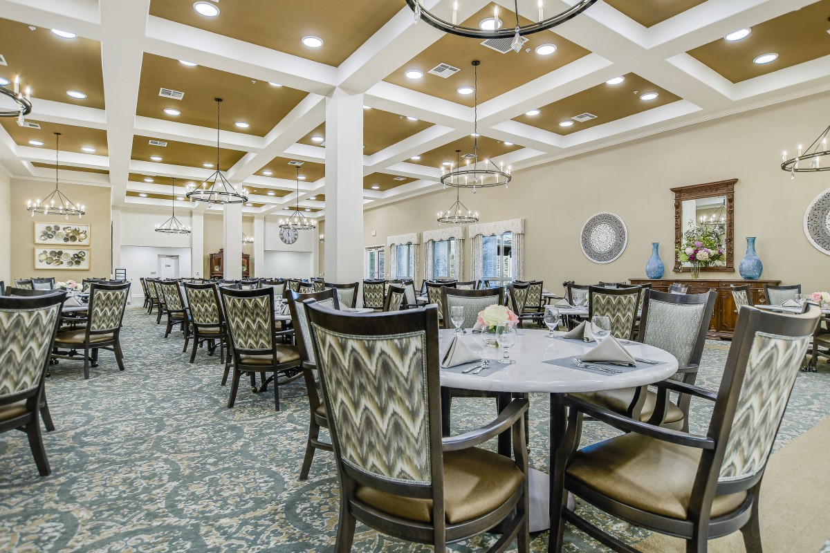 An elegant dining room with beautifully arranged tables and chairs.