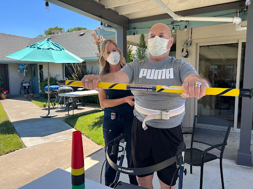 A physical therapy session outdoors, focusing on strength and rehabilitation activities.