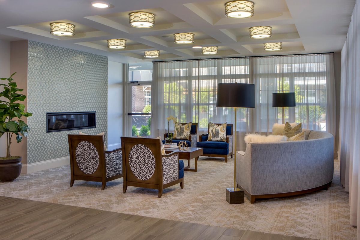 A modern and elegantly designed living room with stylish seating and unique lighting fixtures.