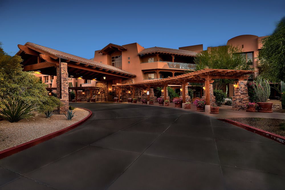 A welcoming entrance to a resort hotel during the evening.