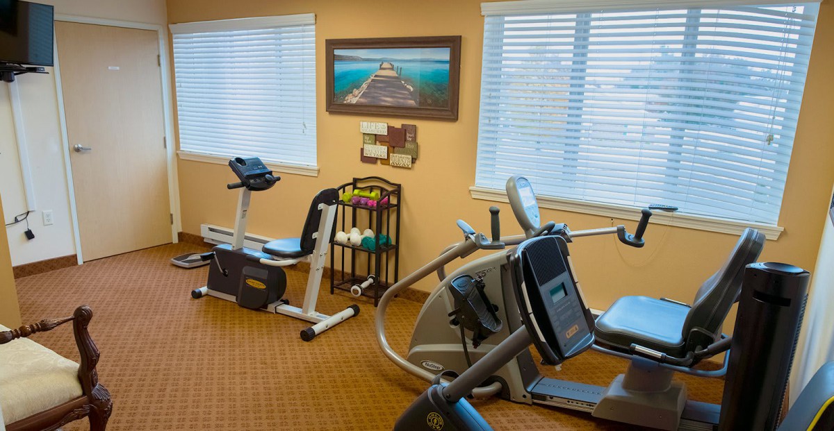 A small fitness room with exercise equipment including a stationary bike and treadmill.
