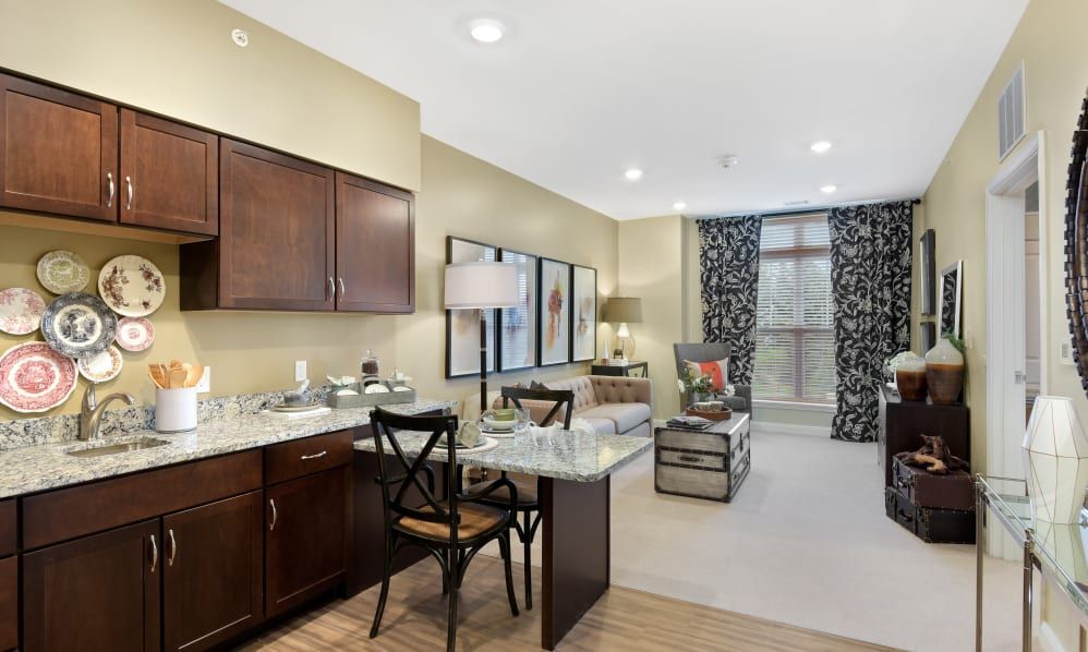 A cozy apartment interior featuring a modern living area with a kitchenette and dining space.