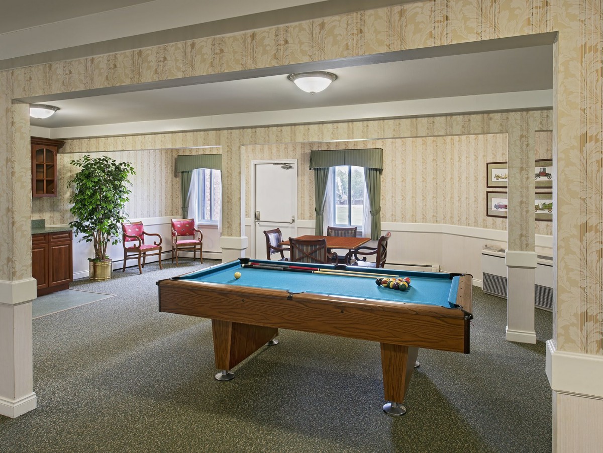 A cozy recreational room featuring a pool table and seating area.