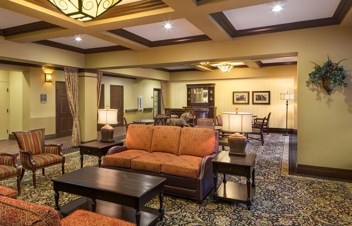A cozy hotel lobby with a seating area, warm lighting, and elegant interior design.