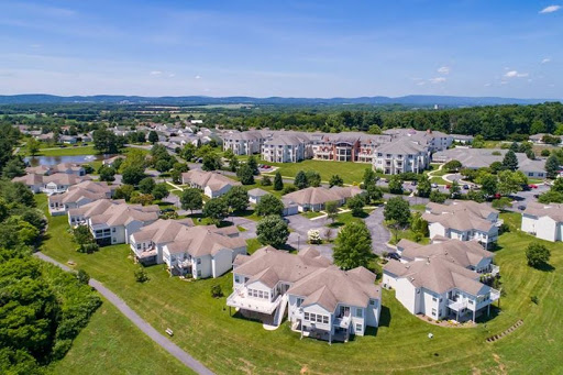 A picturesque aerial view of a suburban residential community surrounded by greenery.