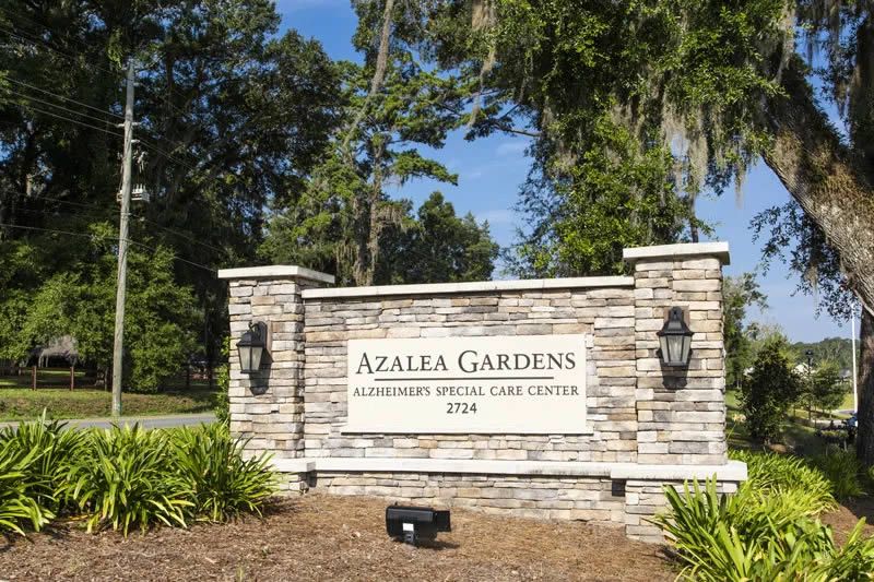 Entrance sign for Azalea Gardens with brick and stone design.