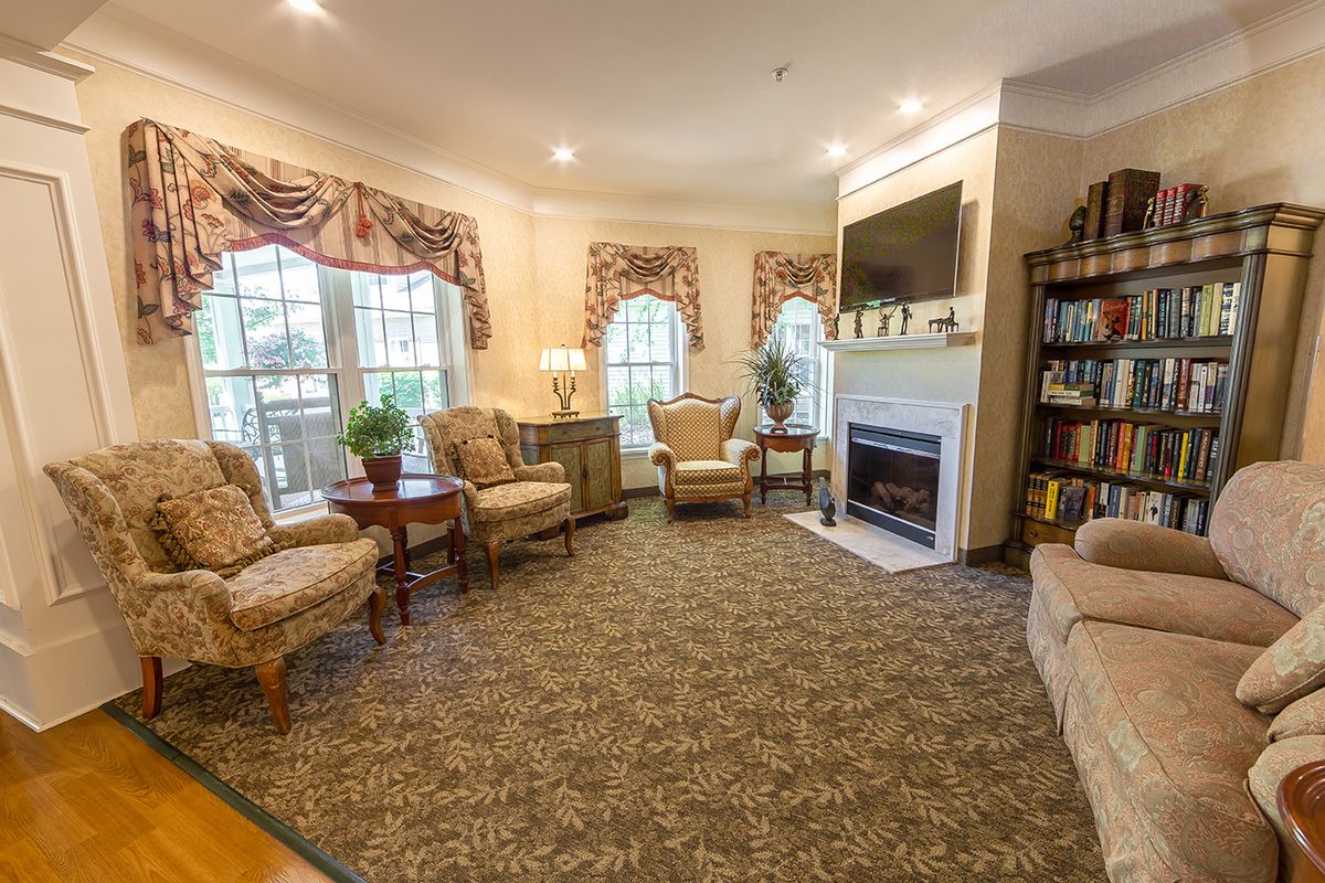 A cozy living room with elegant furniture and a warm fireplace.