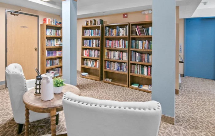 A cozy library interior with bookshelves and a comfortable reading area.