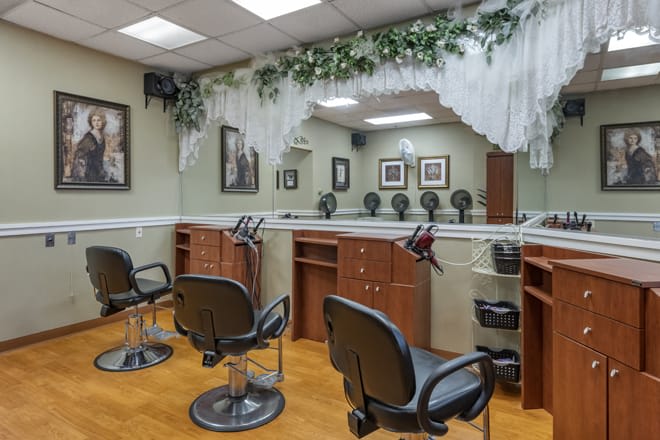 A well-organized hair salon interior with several styling stations and decorative elements.
