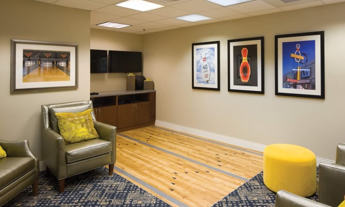 A modern lobby area featuring a comfortable seating arrangement and contemporary artwork.