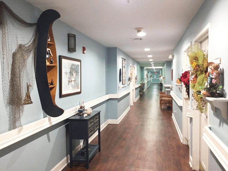 A modern hallway with artwork and decor along the walls.