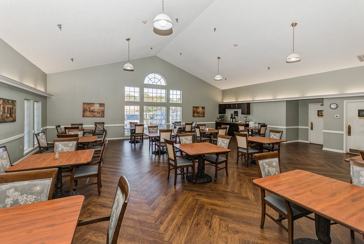 A spacious dining area with neatly arranged tables and chairs, featuring a modern interior design.