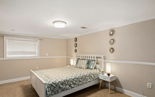 A cozy and modern bedroom featuring a stylish bed, decorative wall accents, and soft lighting.