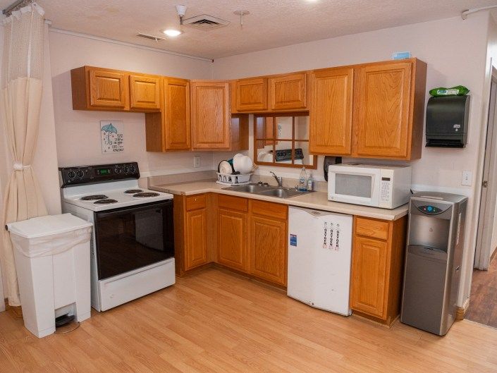 A cozy kitchen with wooden cabinets and modern appliances.