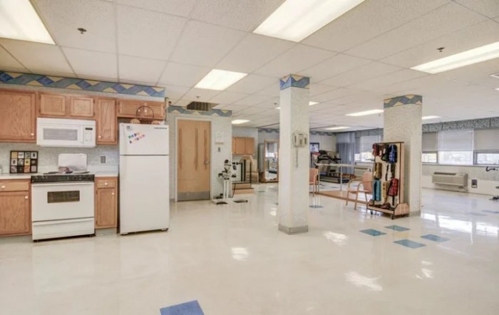 Spacious kitchen area with appliances and ample lighting.