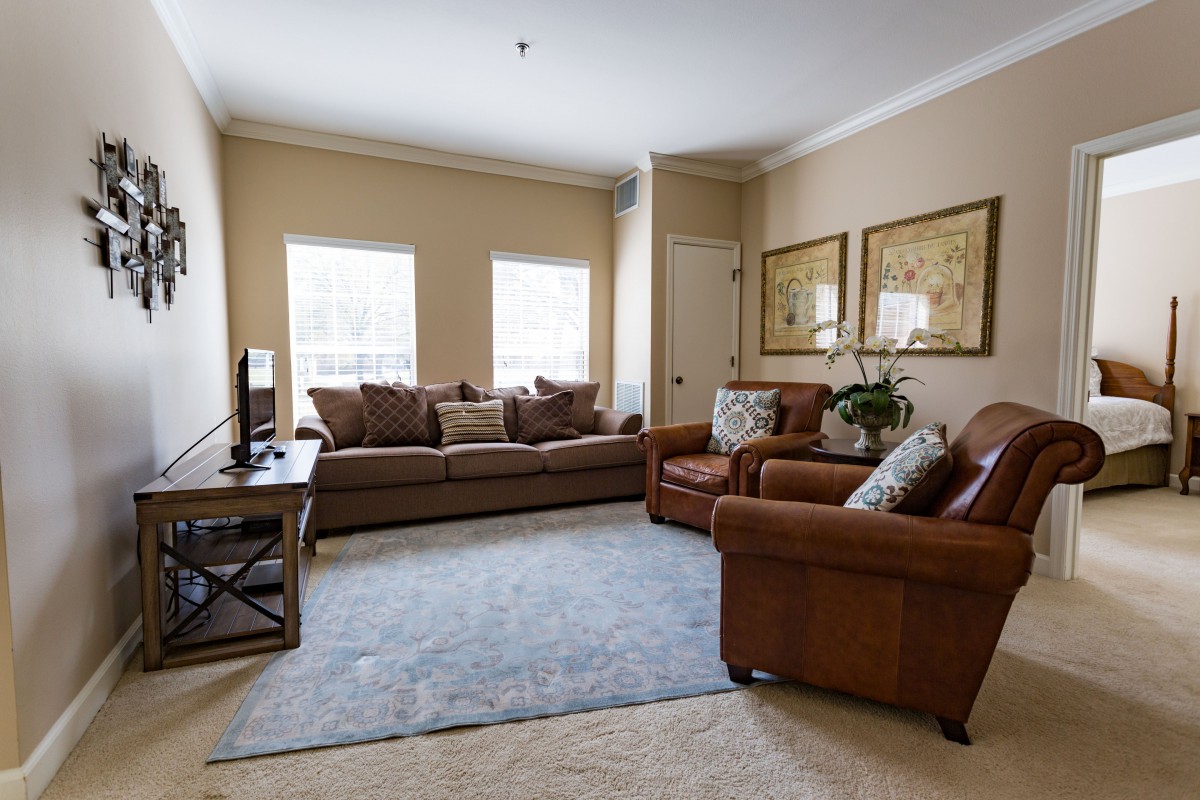 A cozy living room with comfortable sofas and a television.