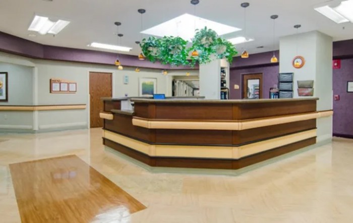 A clean and organized hospital reception area with a front desk.