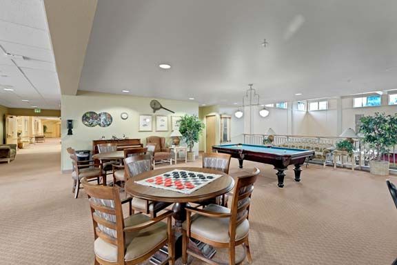 An inviting game room featuring a pool table and chess set, perfect for leisure activities.