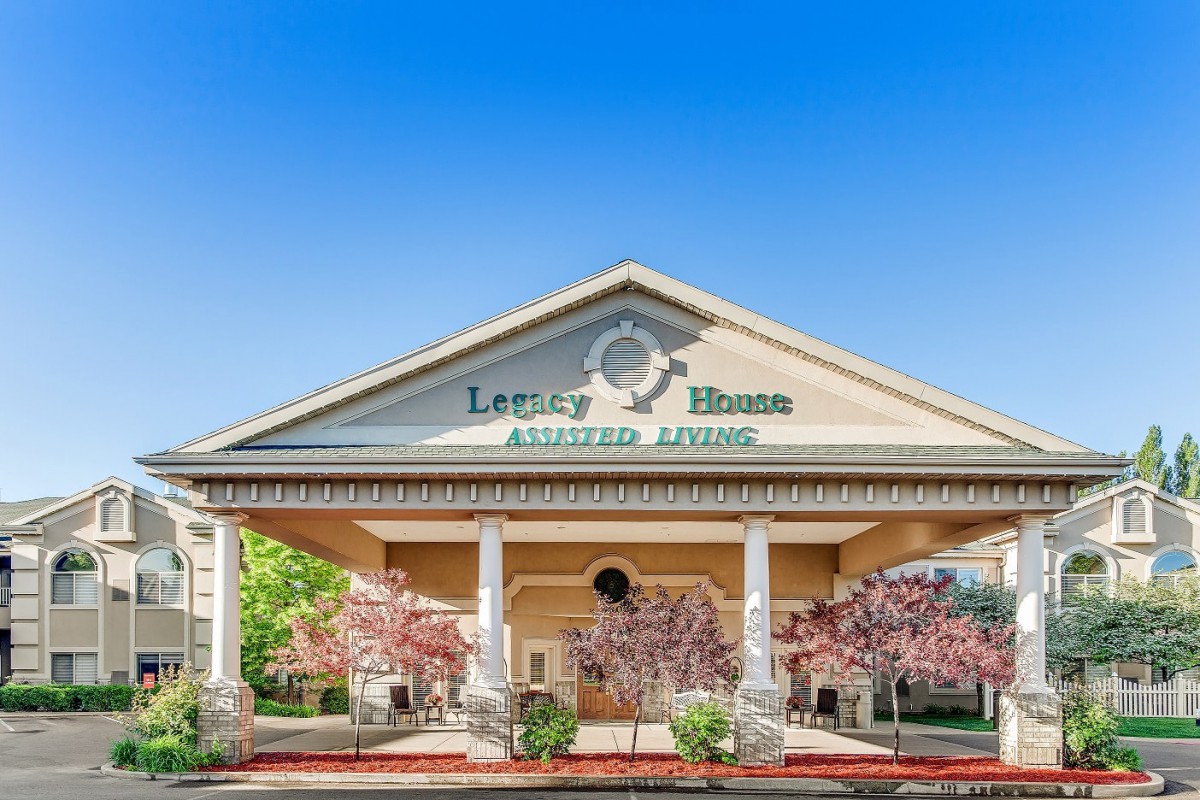 Entrance of an assisted living facility with elegant architecture.