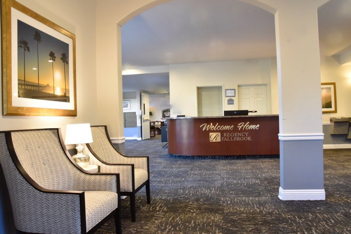 A cozy lobby with a welcome desk and comfortable seating area.