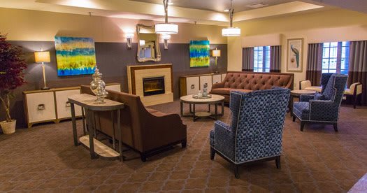 A cozy lobby seating area with modern furniture and a fireplace.