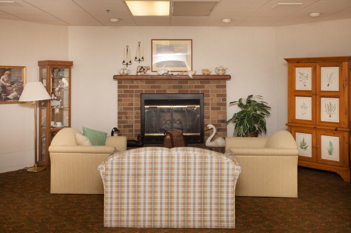 A cozy living room with a brick fireplace and comfortable seating.