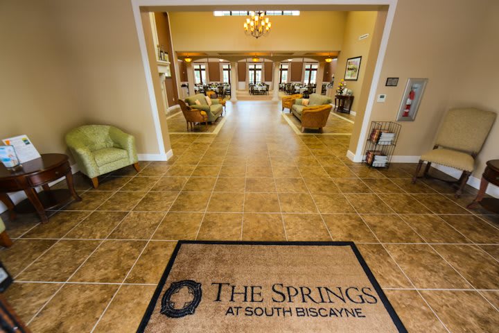 The interior lobby of The Springs at South Biscayne, featuring elegant decor and comfortable seating.
