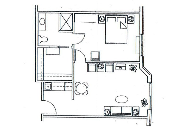 A floor plan of a small apartment showing the layout of rooms and furniture.
