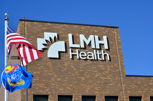 The exterior of LMH Health featuring their logo and an American flag.