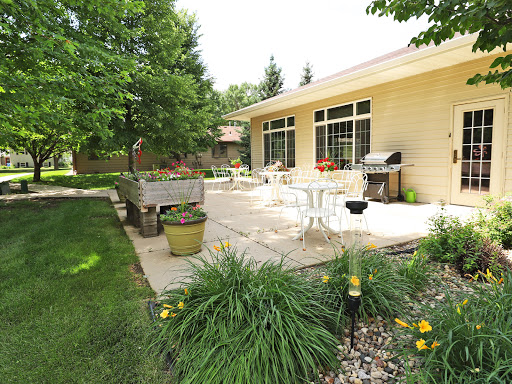 A serene outdoor patio space surrounded by lush greenery, perfect for relaxation and gatherings.