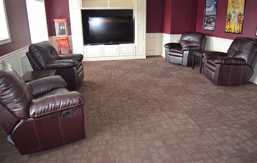 A cozy living room featuring brown leather recliners and a large television.