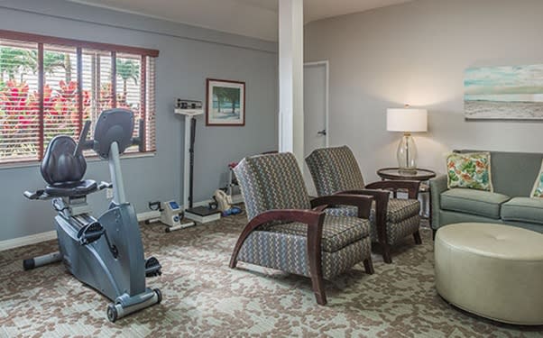 A cozy room with exercise equipment and comfortable seating.