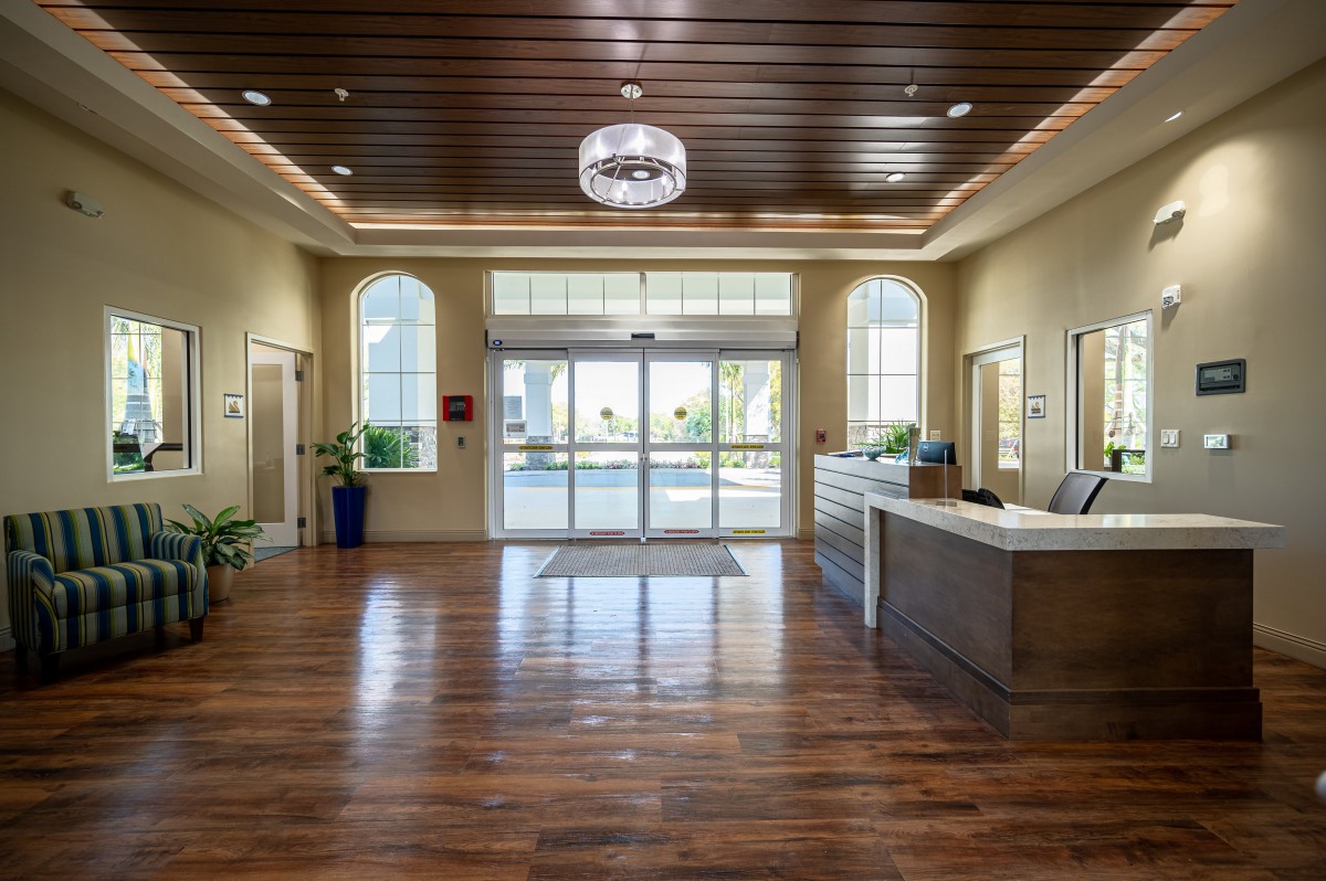A modern lobby with a welcoming reception area and stylish wood flooring.