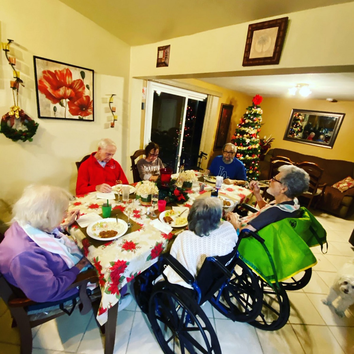 A group of elderly individuals having a meal together at a festive dinner table.