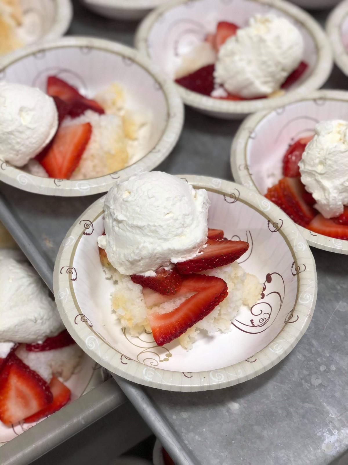 Delicious desserts served with fresh strawberries and whipped cream.
