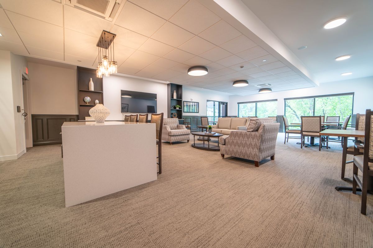 A modern and spacious living room with cozy seating and stylish decor.