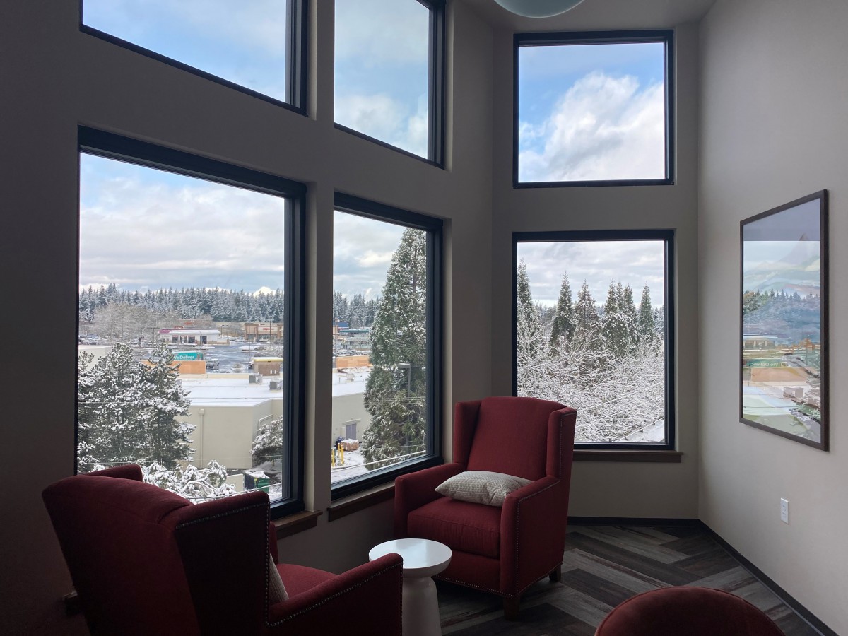 A cozy lounge area with large windows offering a scenic view.