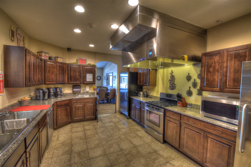 A spacious and modern kitchen featuring wooden cabinets and stainless steel appliances.