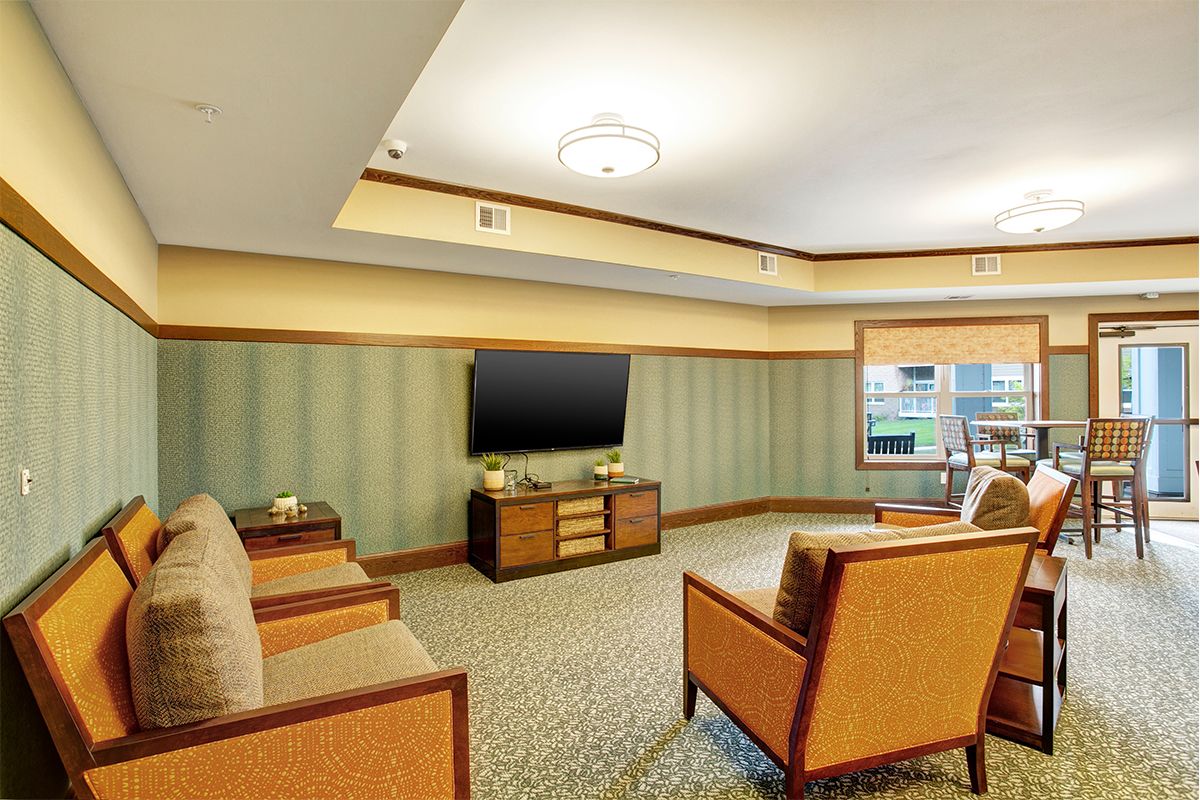 A modern living room with comfortable seating and a flat-screen TV.