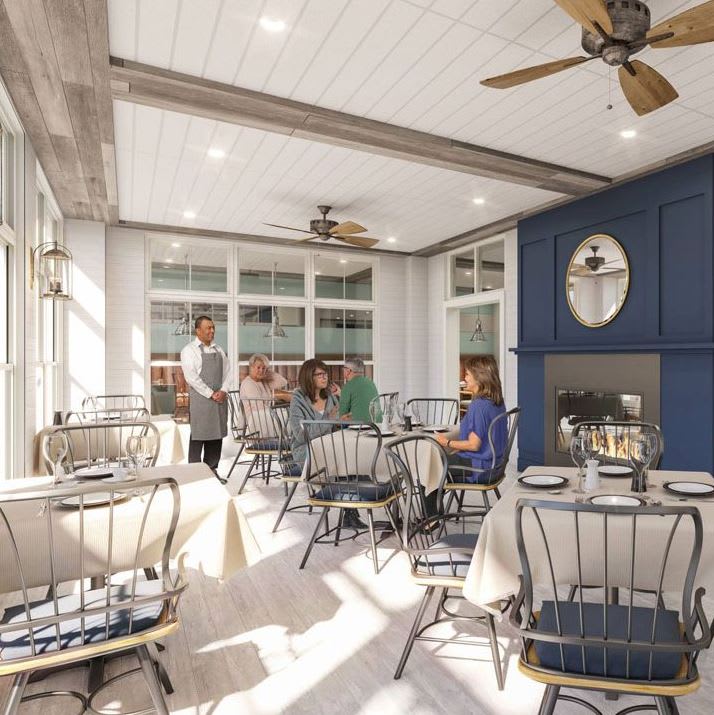 A cozy restaurant dining area with tables set for guests, featuring elegant decor and ceiling fans.
