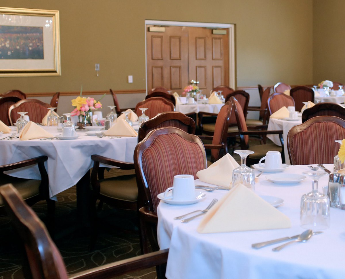 An elegant dining room with tables set for guests.